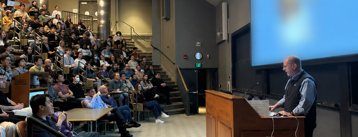 A crowd of people watching our Cell Bio Seminar speaker present in the Armenise Amphitheater